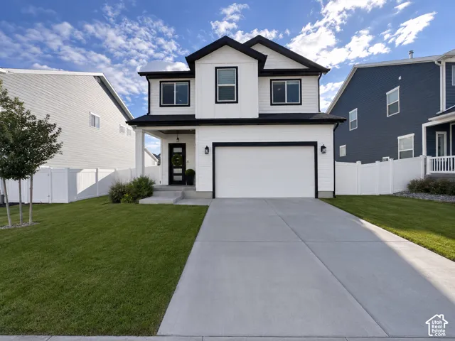 Two-story residence featuring white siding with black trim accents and a covered porch entry