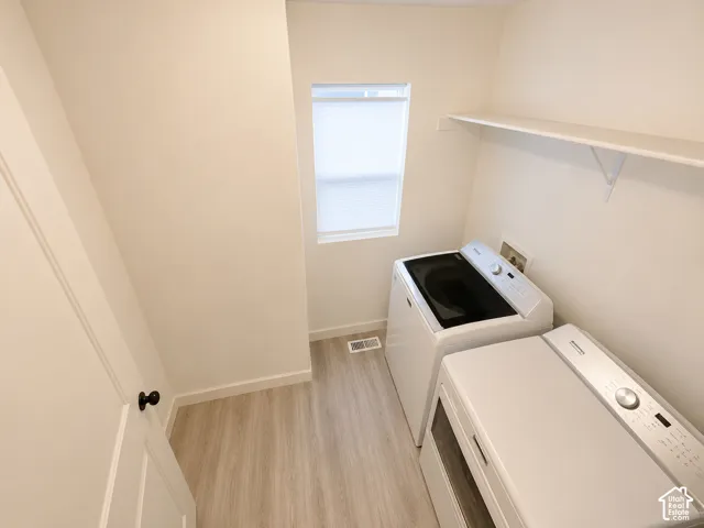 Window with blinds, shelving, and wood-finish flooring