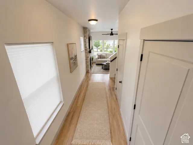 Light wood-finish flooring with white walls