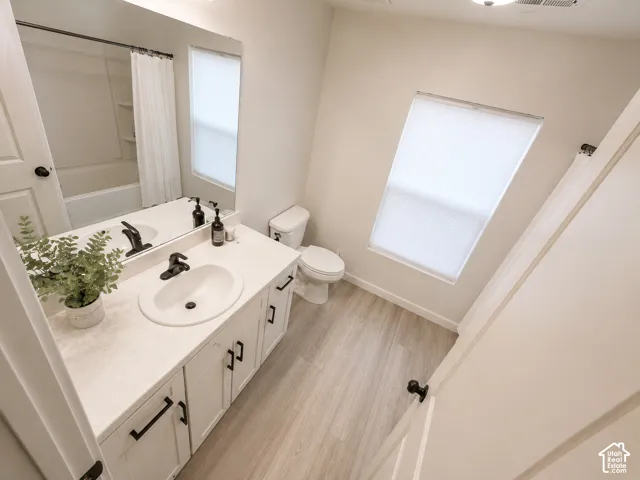 White vanity with matte black hardware, integrated sink, and white countertop