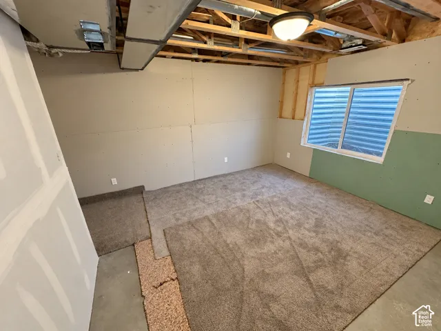 New construction with exposed ceiling joists, recessed window, and ample floor space
