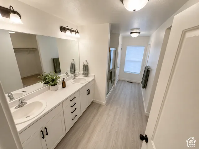 Dual vanity with white cabinetry and black hardware