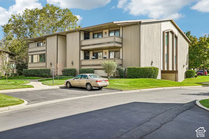Modern multi-level residence featuring a distinctive angular architectural design with vertical metal siding accents and horizontal banding