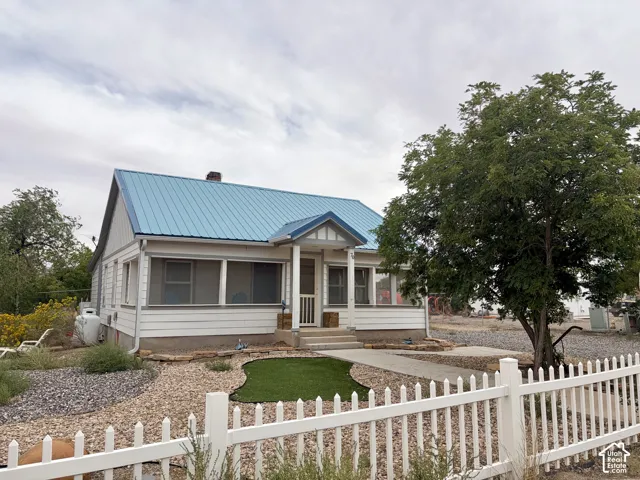 White siding exterior with a blue metal roof