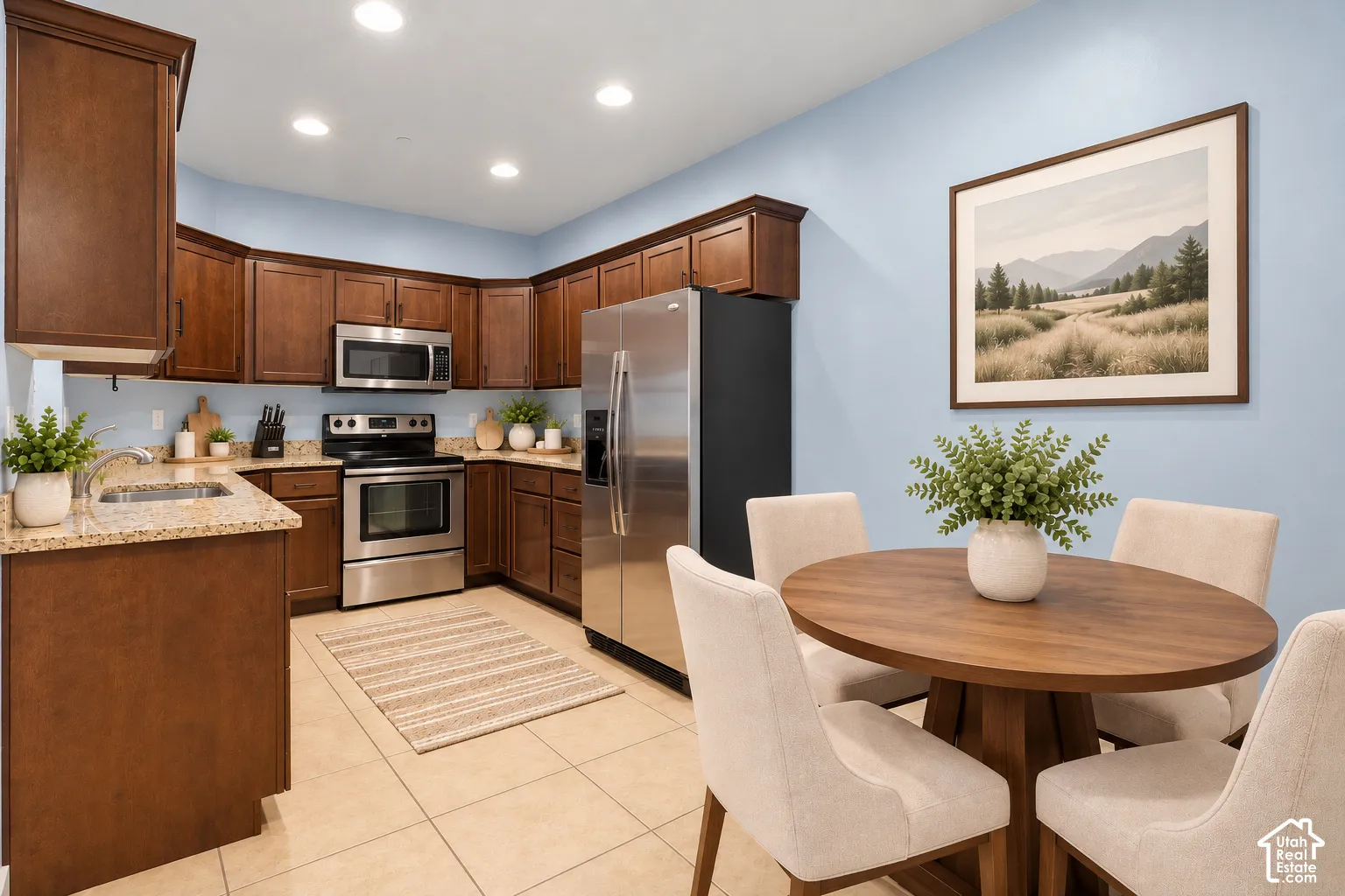 Well-appointed kitchen featuring a stainless steel appliance suite, wood cabinetry, granite countertops, and recessed lighting