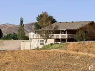 Log-style siding with a covered balcony and white railing