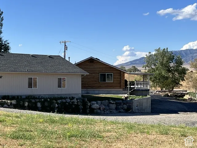 Wood-sided dwelling with covered porch and mountain backdrop