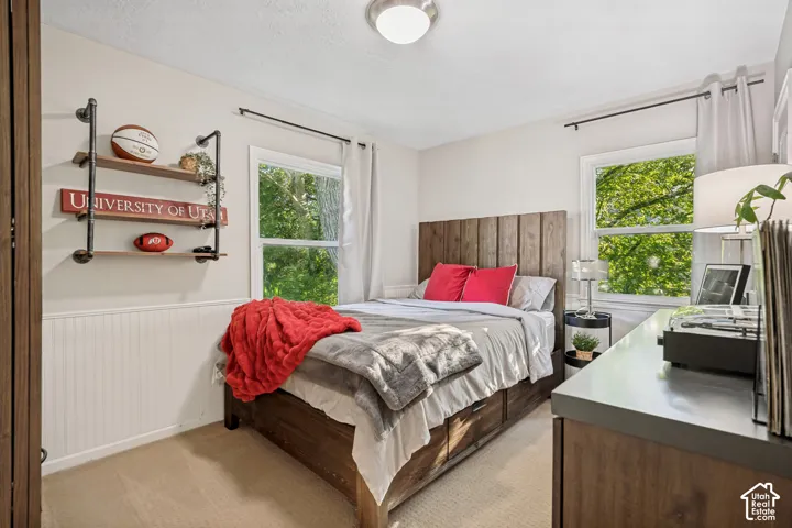 Recessed lighting, wood-finish panel headboard, built-in shelving, dual windows, and wall paneling