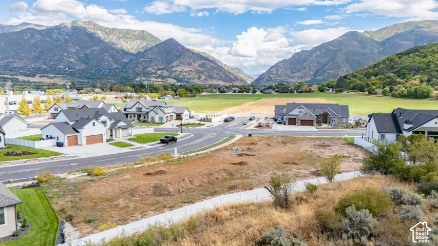 Mountain backdrop with a residential development featuring newly constructed homes