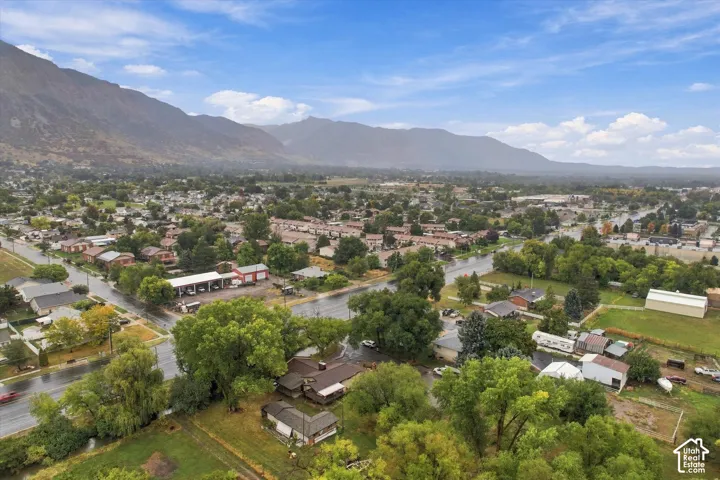 Expansive community featuring mature trees, residential properties, and clear mountain scenery