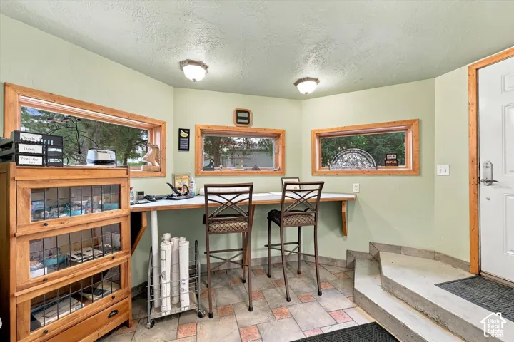 Built-in wood-finish shelving, an integrated desk, and multiple windows with wood-finish trim