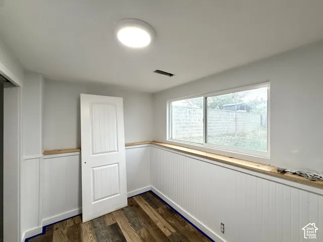 Wood-finish flooring with white wainscoting and trim