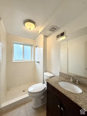 Shower with white tile surround, privacy window, and grab bar