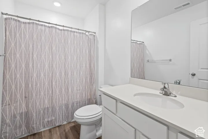 White vanity with an integrated sink, polished chrome faucet, and a large wall-mounted mirror