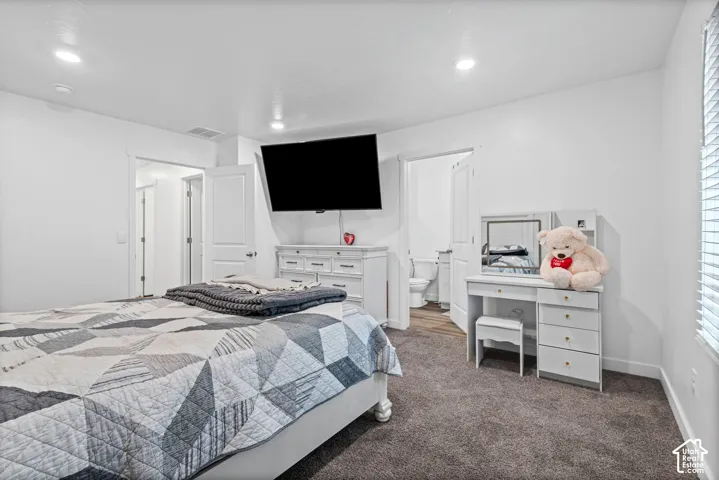 White interior walls with recessed lighting, gray carpeting, white trim, and white doors