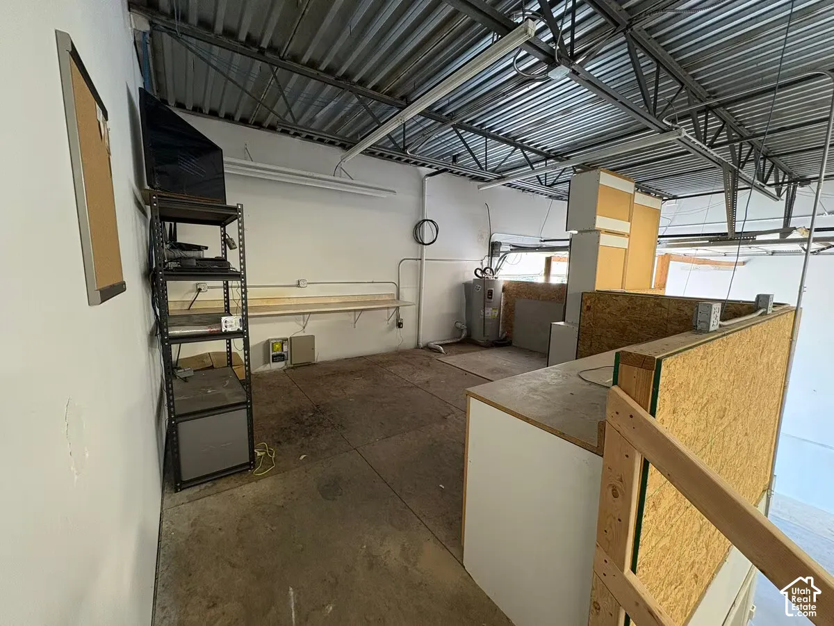 Exposed ceiling structure with metal trusses and corrugated roof decking