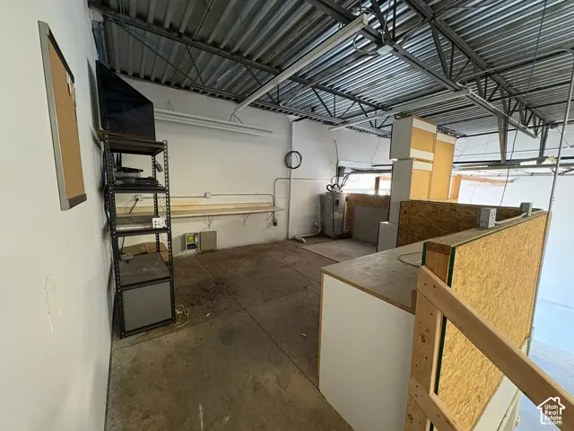 Exposed ceiling structure with metal trusses and corrugated roof decking