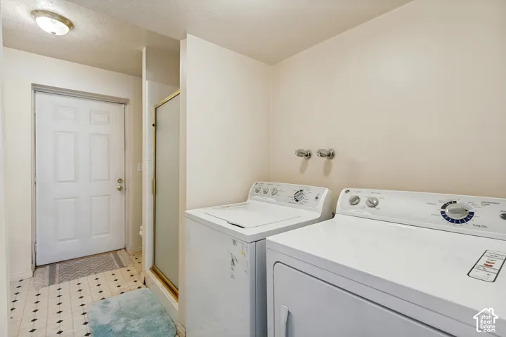 White paneled door, built-in light fixture, and black and white checkered floor tiles