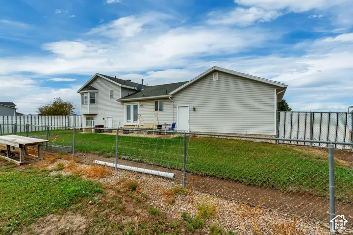 Rear exterior featuring light-colored siding, a bay window, and a deck with direct access