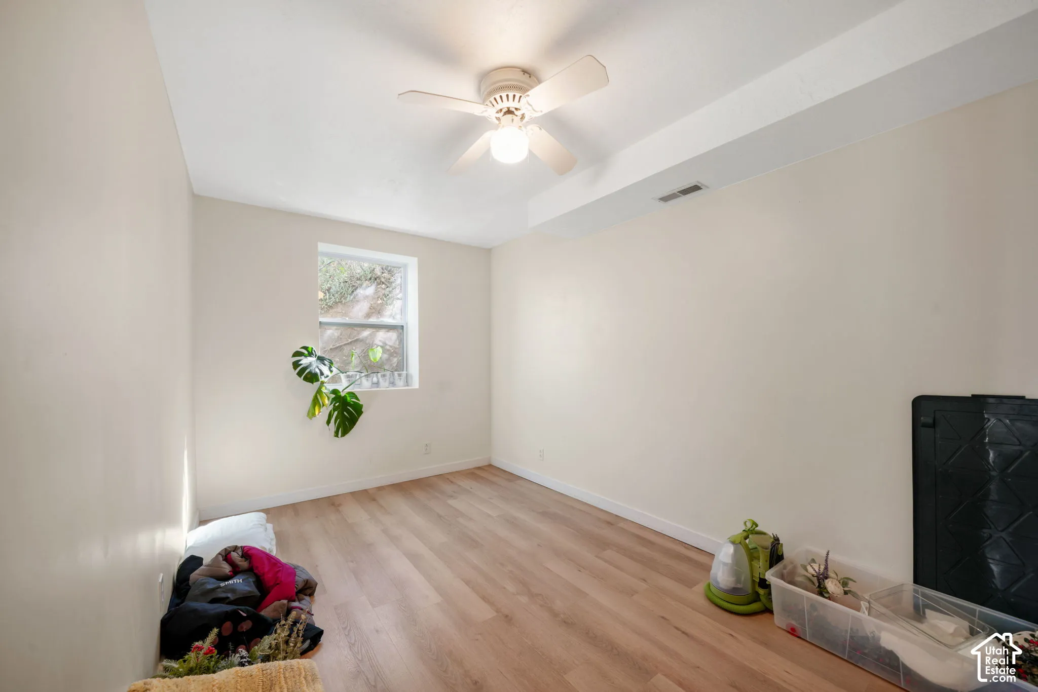 Recessed window, wood-finish flooring, ceiling fan, and overhead lighting