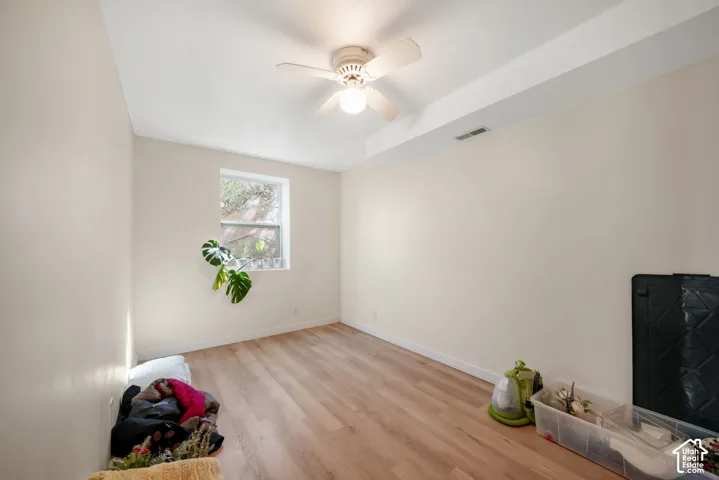 Recessed window, wood-finish flooring, ceiling fan, and overhead lighting
