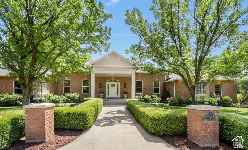 Brick exterior with a prominent portico entrance and white columns