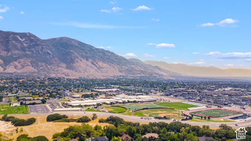 Mountainous backdrop, extensive urban development, stadium, baseball field, and numerous residential structures