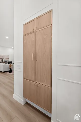 Built-in cabinetry with wood-finish doors and brass hardware