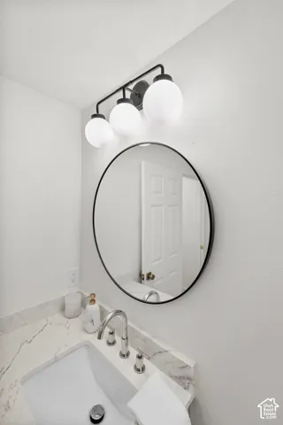 Integrated vanity with an undermount sink, a chrome faucet, and a stone countertop