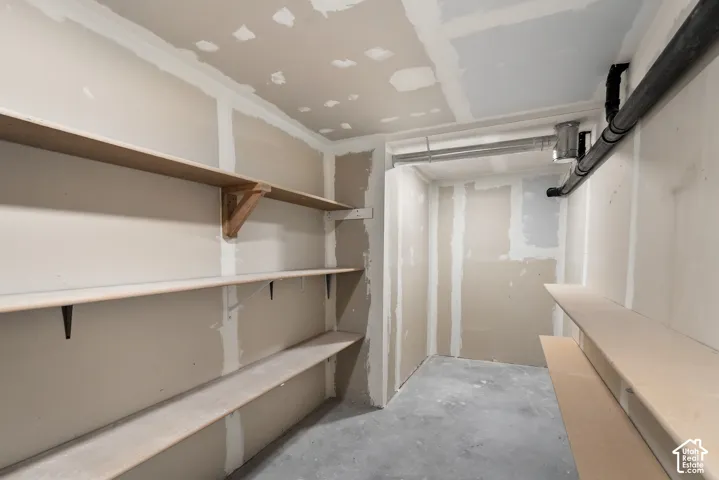 Drywall interior with unfinished concrete flooring