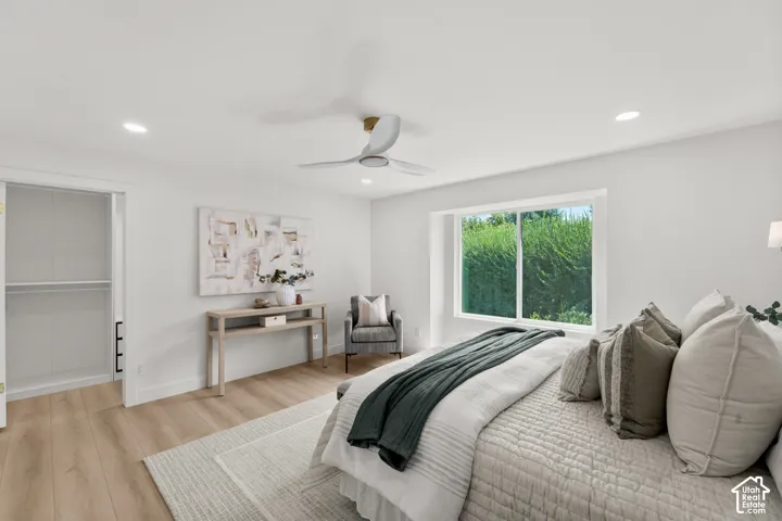 Recessed lighting, wood-finish flooring, and a ceiling fan with integrated lighting
