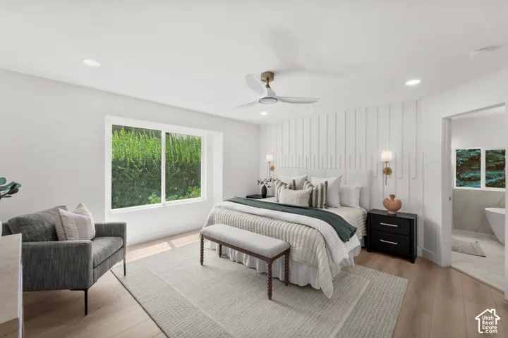 Light wood-finish flooring, recessed lighting, and a modern ceiling fan with integrated lighting