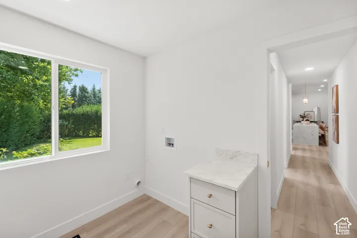 Bright interior with wood-finish flooring and a white window frame