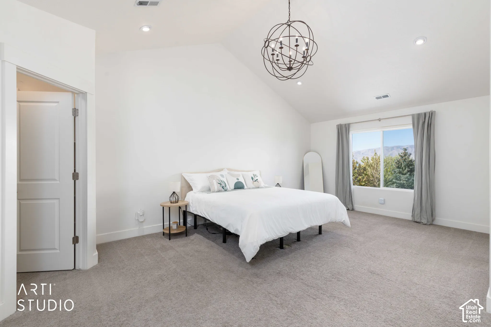 Vaulted ceiling with a spherical chandelier and recessed lighting