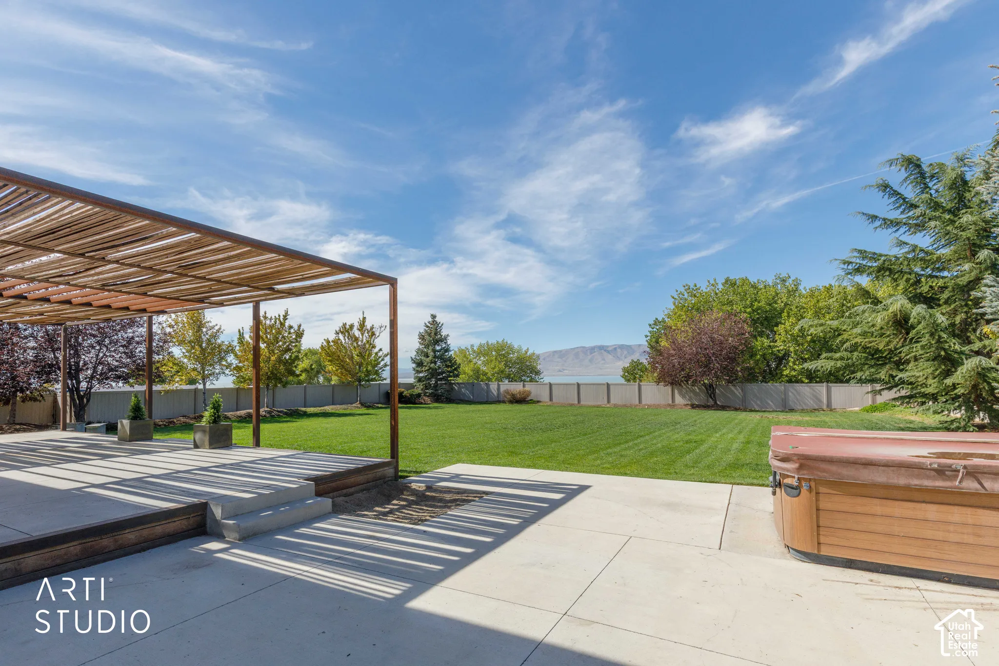 Patio featuring a slatted pergola, concrete steps, and a wood-tone deck