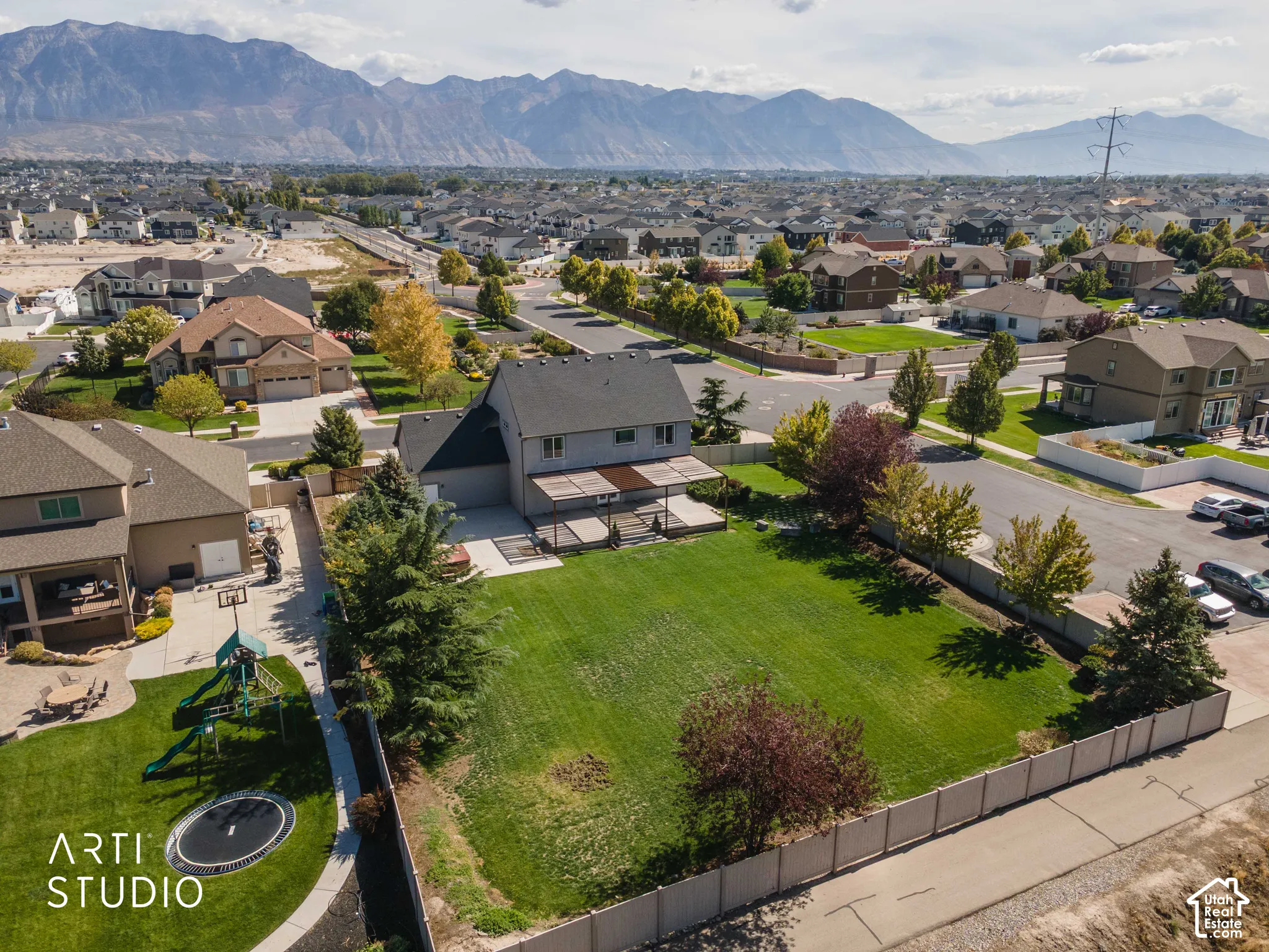 Expansive lawn area with a rear patio featuring a pergola