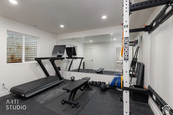 Recessed lighting, wall-mounted mirrors, and durable flooring with a window