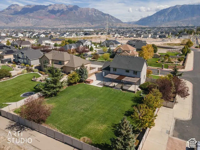 Expansive green lawn with mature trees and perimeter fencing