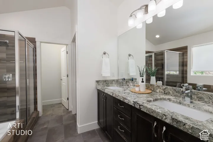 Dual vanity with granite countertops, undermount sinks, and dark wood-finish cabinetry