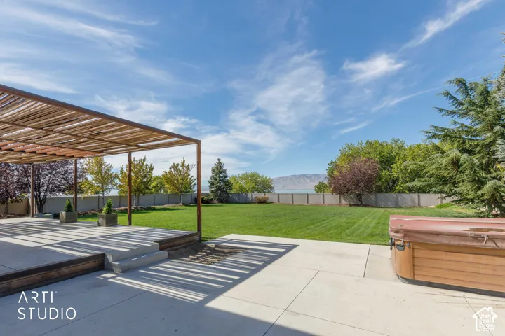 Patio featuring a slatted pergola, concrete steps, and a wood-tone deck