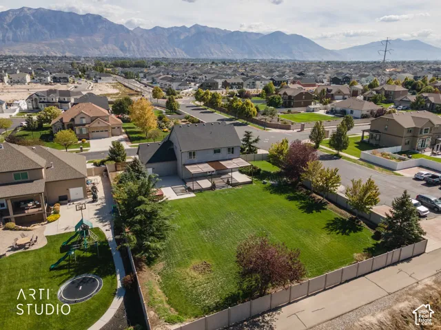 Expansive lawn area with a rear patio featuring a pergola