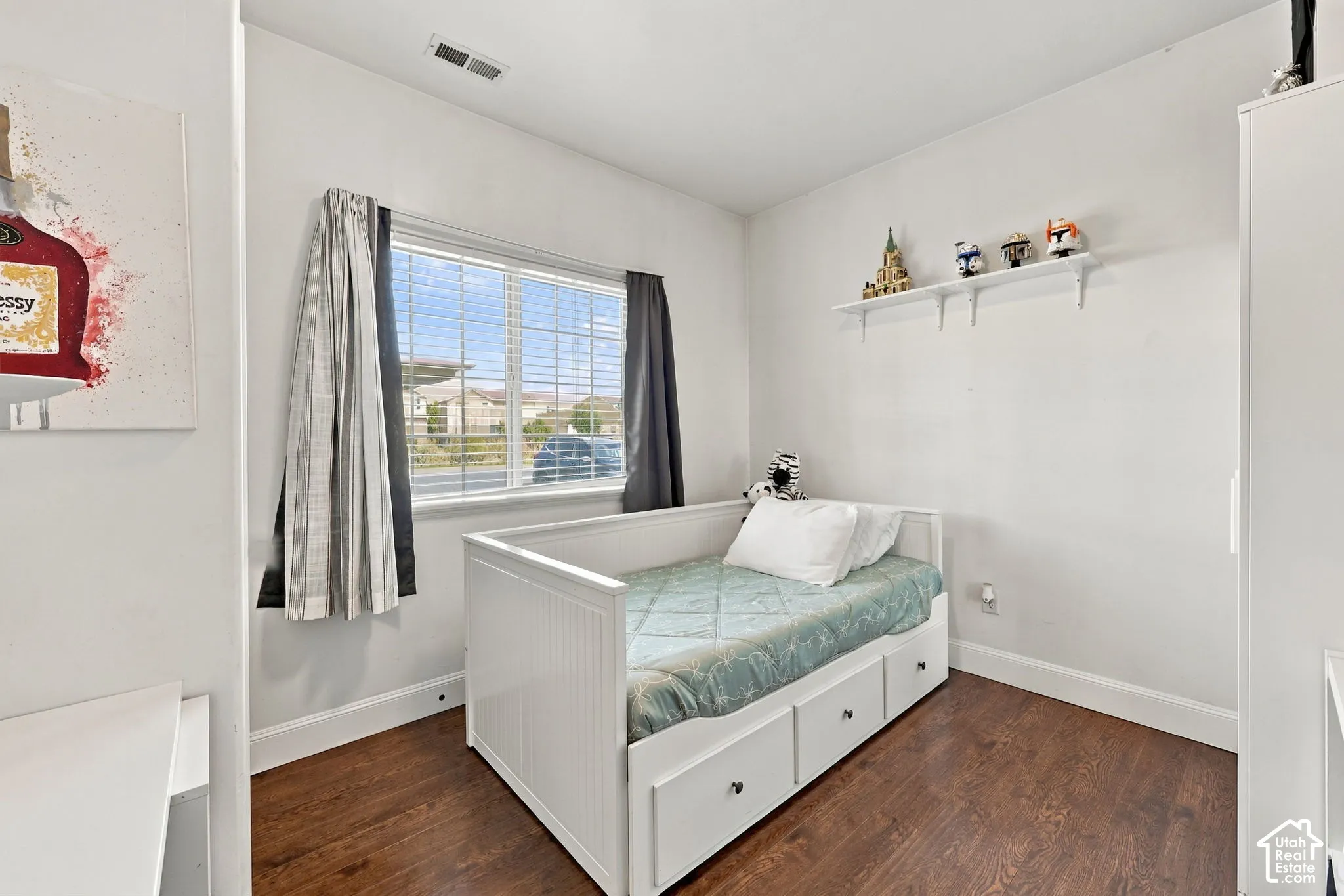Hardwood-finish flooring, white walls, and a built-in wall shelf