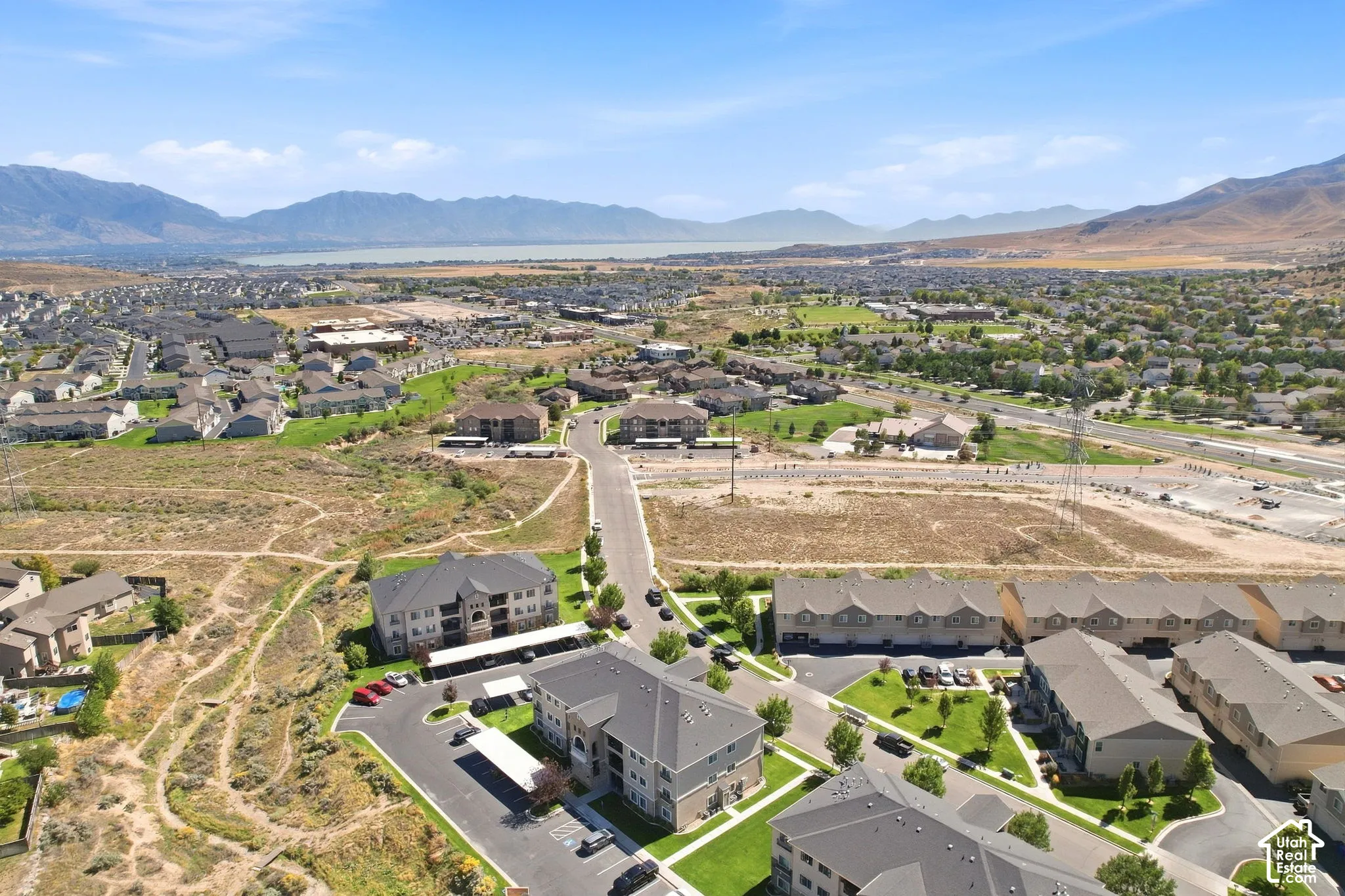 Expansive residential area with a prominent body of water in the background, surrounded by distant mountains