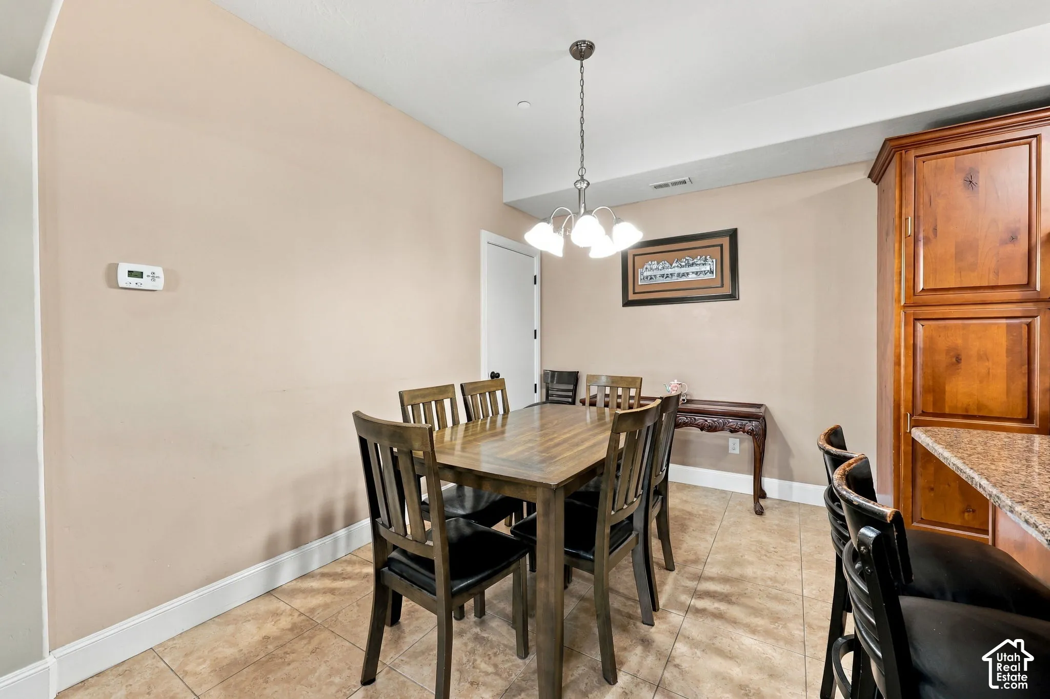 Tile flooring, recessed ceiling lighting, and a multi-light chandelier