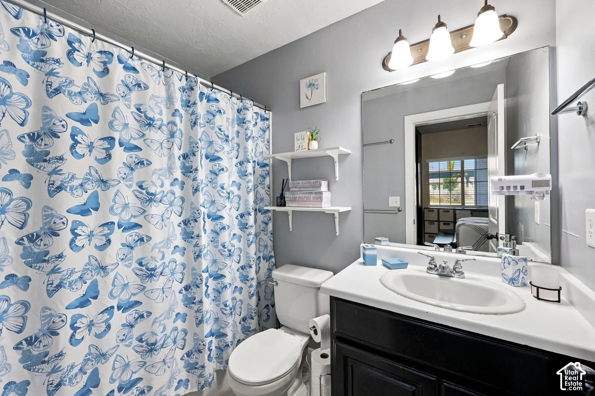 White vanity with an integrated sink and dark wood-finish cabinetry