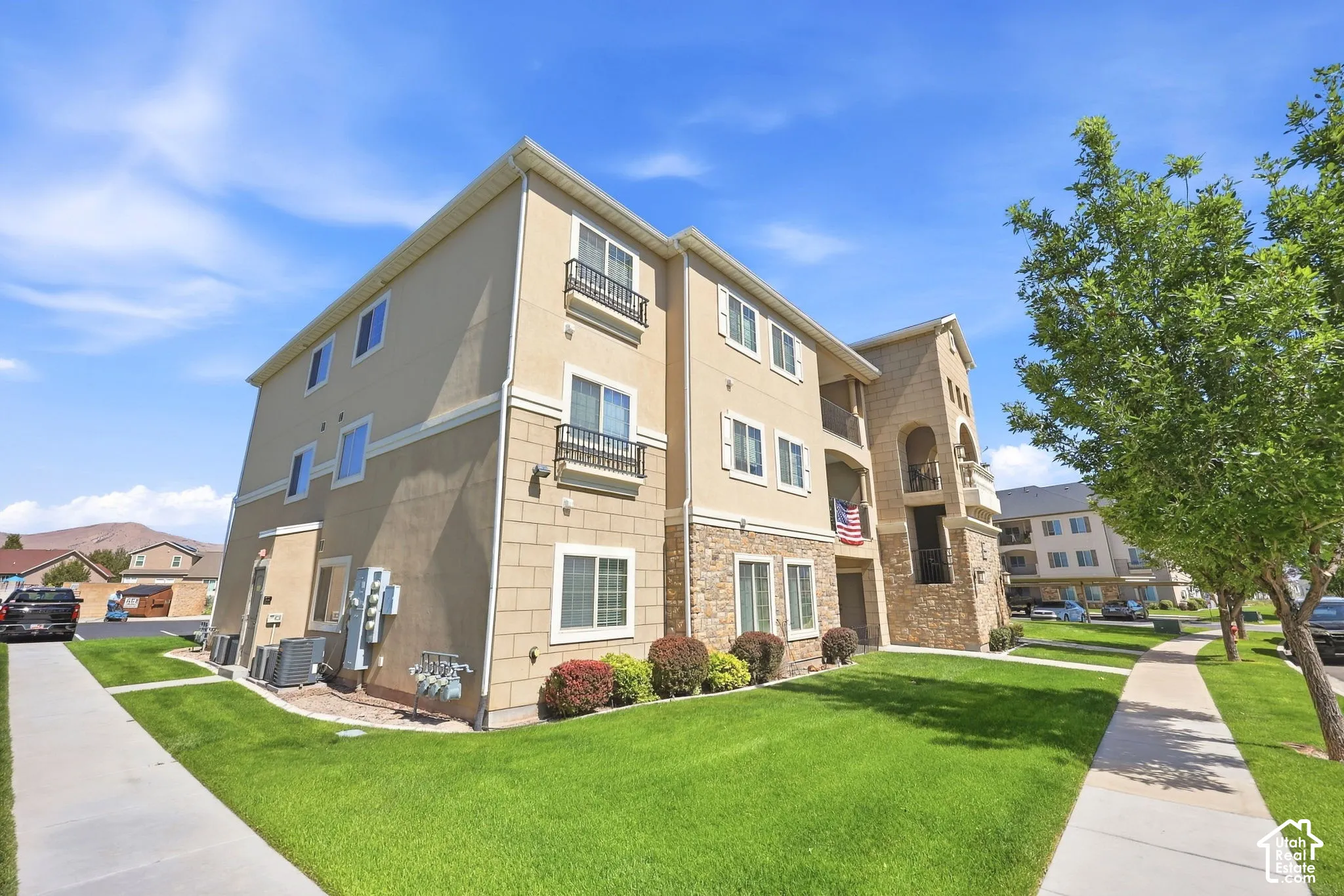 Multi-story building featuring a stucco and stone veneer exterior