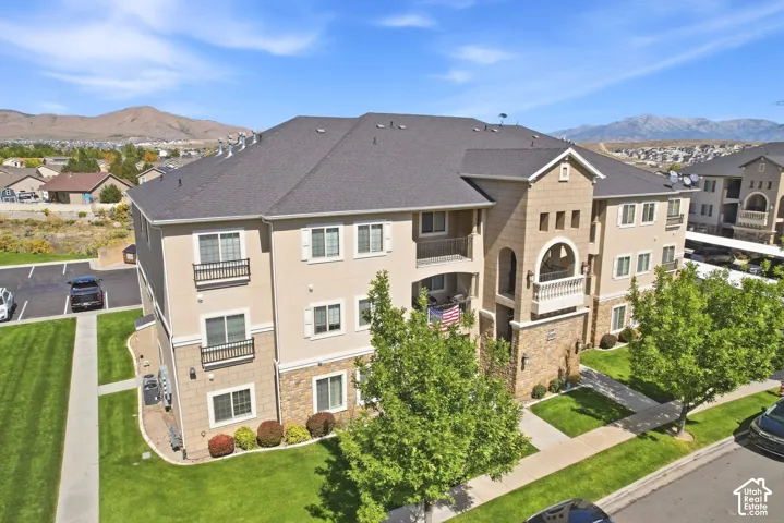 Multi-story building featuring stucco and stone veneer exterior