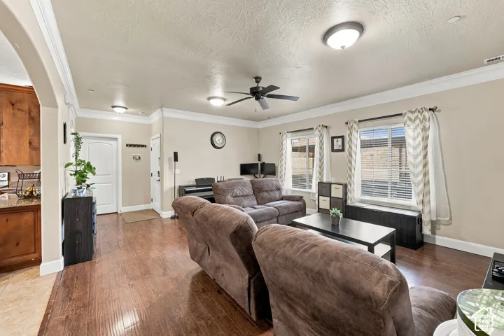 Wood-finish flooring throughout, complemented by crown molding and recessed lighting