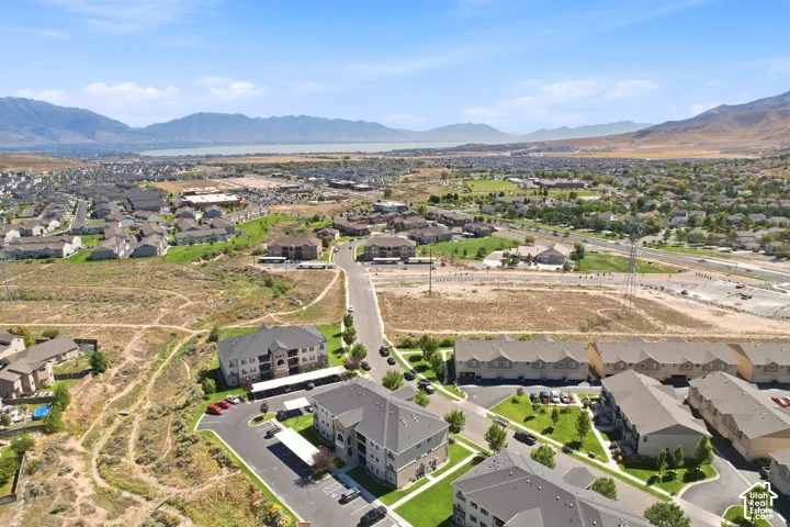 Expansive residential area with a prominent body of water in the background, surrounded by distant mountains