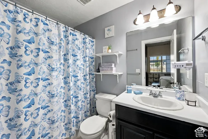 White vanity with an integrated sink and dark wood-finish cabinetry